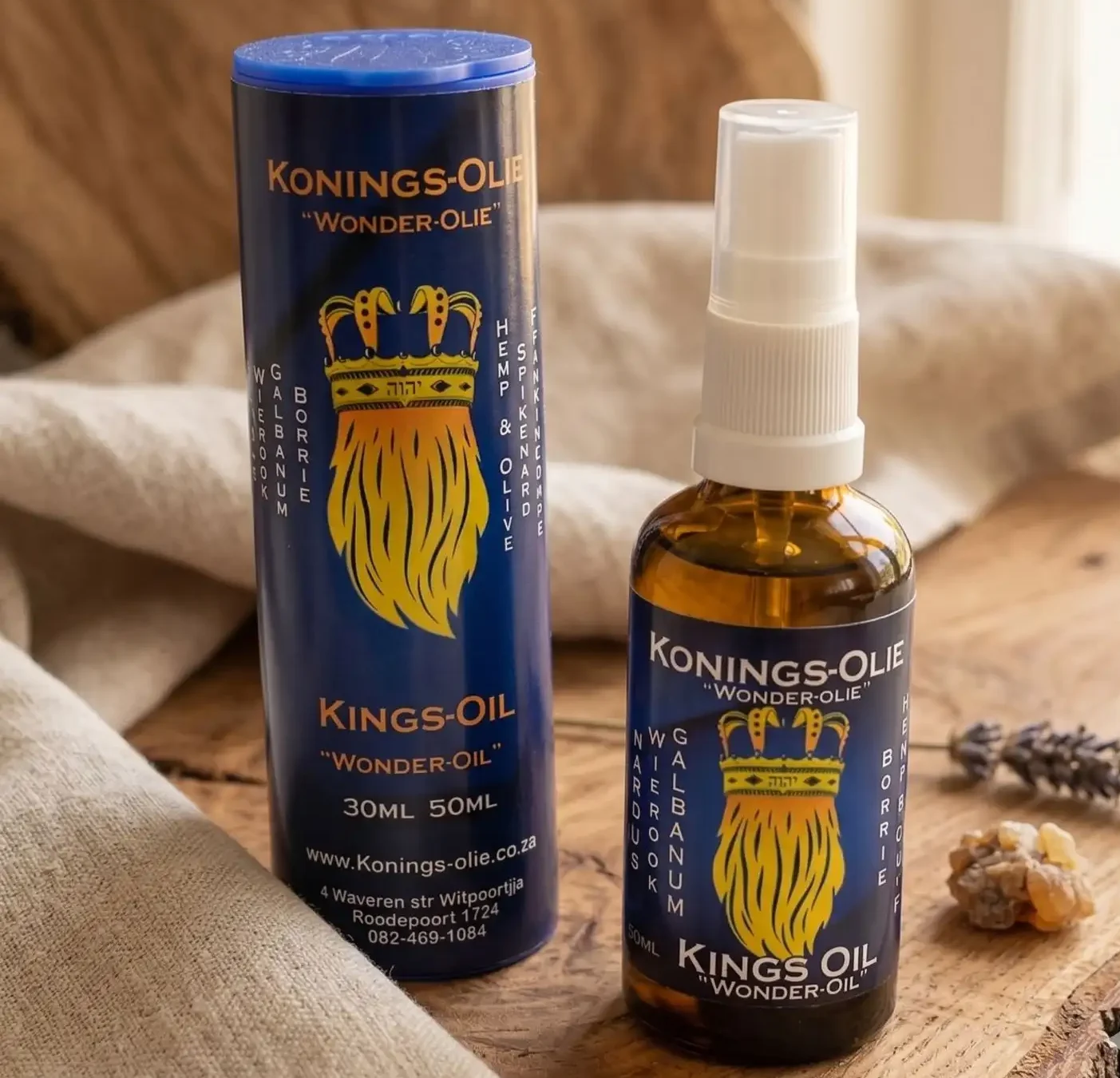 Kings-Oil Wonder-Oil spray bottle and tube packaging on raw wood, a South African healing oil blend containing spikenard