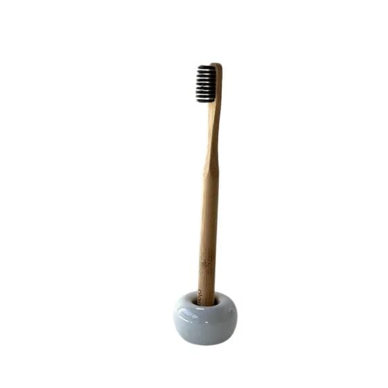 Olgani Naturals SilkBrush bamboo toothbrush in ceramic stand — charcoal bristle plastic-free toothbrush available at Toeka