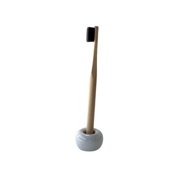 Olgani Naturals Cloud bamboo toothbrush in ceramic stand — ultra-soft charcoal bristle plastic-free toothbrush available at Toeka